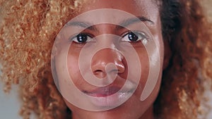 Close up portrait face young blonde African American woman nods head and smiles