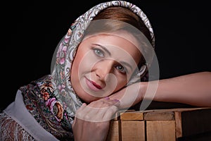 Close up portrait of fashion beautiful slavic style woman in scarf on black background. Studio shot