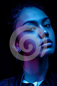 Close up portrait of Fashion young american African girl woman camera isolated on a black Studio background, portrait, copy space