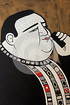 Close-up portrait of a fat man in traditional clothing holding a cellphone to his ear.