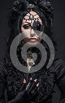 Close up portrait of fatal woman in vintage black dress and decor on face