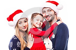 Close up portrait of father, mother and daugher on Christmas holiday.