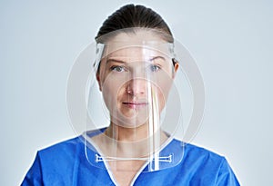 Close up portrait of female medical doctor or nurse wearing face shield