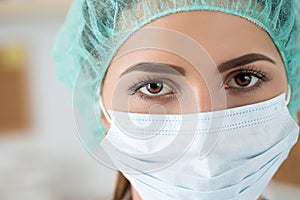 Close-up portrait of female medicine doctor wearing protective m