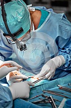 Close up portrait of female surgeon doctor wearing protective mask and hat during the operation. Healthcare, medical