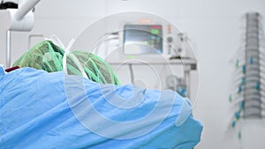 Close-up portrait of female surgeon wearing sterile clothing operating at operating room.