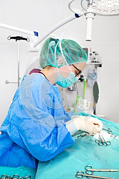 Close-up portrait of female surgeon wearing sterile clothing operating at operating room.