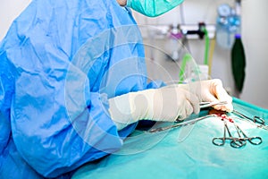 Close-up portrait of female surgeon wearing sterile clothing operating at operating room.