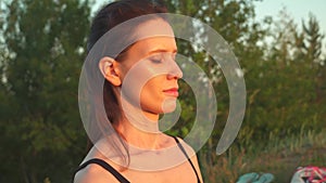 Close up portrait of girl with closed eyes dreaming in natural sunset light.