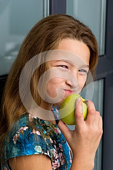 Close up portrait of girl eating apple.