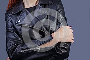 Close-up portrait of a girl in a high-quality leather jacket. Rock and roll style in women. Promotional photo of a leather jacket