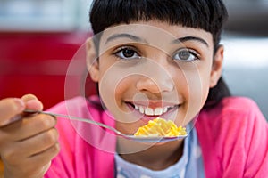 Close-up of portrait of girl holding cereal in spoon