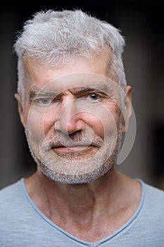 Close up portrait of a gray haired senior man. Sport and health care concept