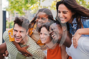 Close up portrait of a group of smiling multiracial teenage friends having fun outdoors. Cherful young people laughing