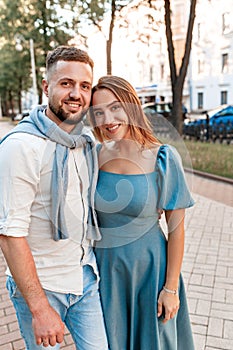 Close up portrait of a handsome couple in love hugging while walking in city