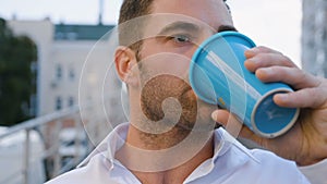 Close-up Portrait of Handsome Man Drinking Delicious Coffee in City Urban Lifestyle. Successful Businessman employee
