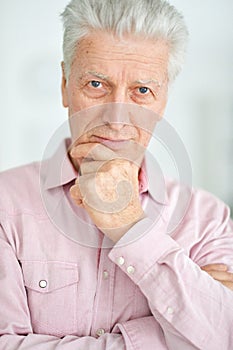 Close-up portrait of handsome senior man thinking