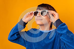 Close up portrait of a handsome teen boy wearing cool white sunglasses.