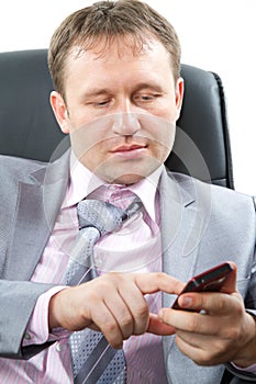 Close up portrait of a handsome young business man in a stylish suit look on watch on his hand , isolated