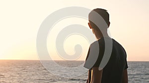 Close up portrait of handsome young man looking thoughtful pensive on seaside background.