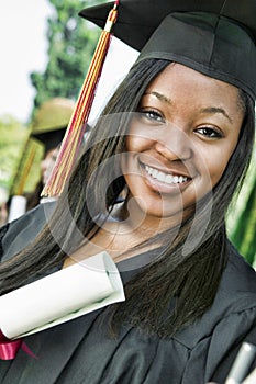 Close up portrait of happy african american female student with certificate in college campus