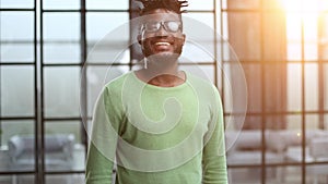 Close up portrait of a happy african american guy smiling with arms crossed