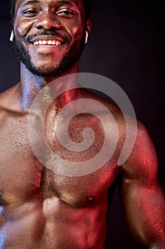 close-up portrait of happy african sweaty sportsman in headphones