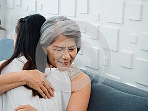 Close-up portrait of happy Asian senior, mother or grandparent white hair embracing her beautiful daughter or grandchild.