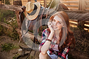 Close up portrait of a happy beautiful redhead cowgirl resting