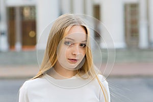 Close-up portrait of a happy blonde girl in casual clothes. Lifestyle concept