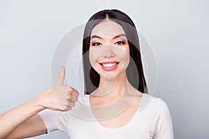 Close up portrait of happy confident smiling girl showing thumb