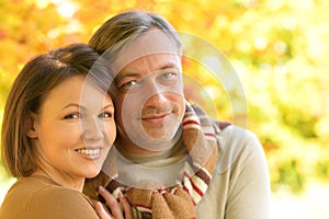 Close up portrait of happy couple posing in park