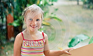Close up portrait of happy cute little girl enjoy summer rain