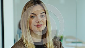 Close up portrait of happy female business leader successful millennial businesswoman posing in office with team