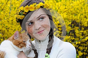 close-up portrait of happy freckled girl and red cat