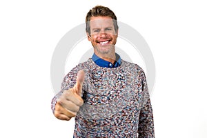 Close-up portrait of happy man showing thumps sign