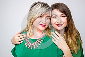 Close up portrait of happy mother and daughter