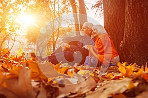 Close up portrait of a happy old woman and man in a park in autumn foliage