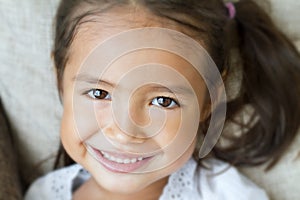 Close-up portrait of happy, positive, smiling, playful girl