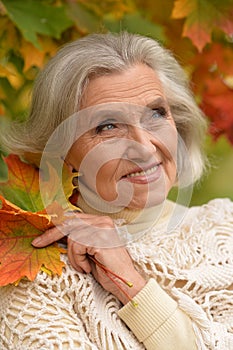 Close up portrait of happy senior beautiful woman in park