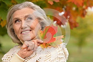 Close-up portrait of happy senior beautiful woman in park