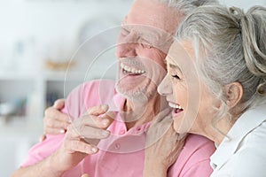 Close up portrait of happy senior couple at home