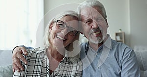 Close up portrait happy senior couple looking at camera