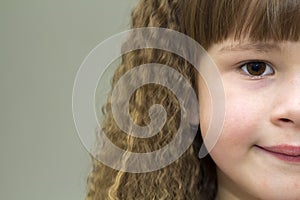 Close up portrait of happy smiling little girl with beautiful th