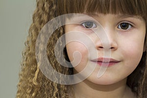 Close up portrait of happy smiling little girl with beautiful th