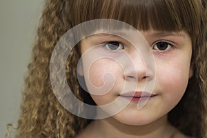 Close up portrait of happy smiling little girl with beautiful th