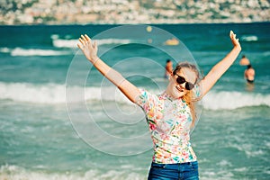 Close up portrait of happy teenage girl posing by the sea