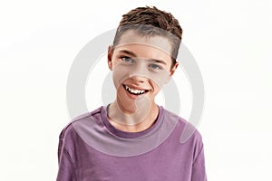 Close up portrait of happy teenaged disabled boy with cerebral palsy smiling at camera, posing isolated over white