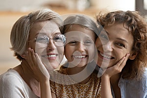 Close up portrait of happy three female generations family.