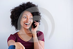 Happy young african woman talking on cell phone